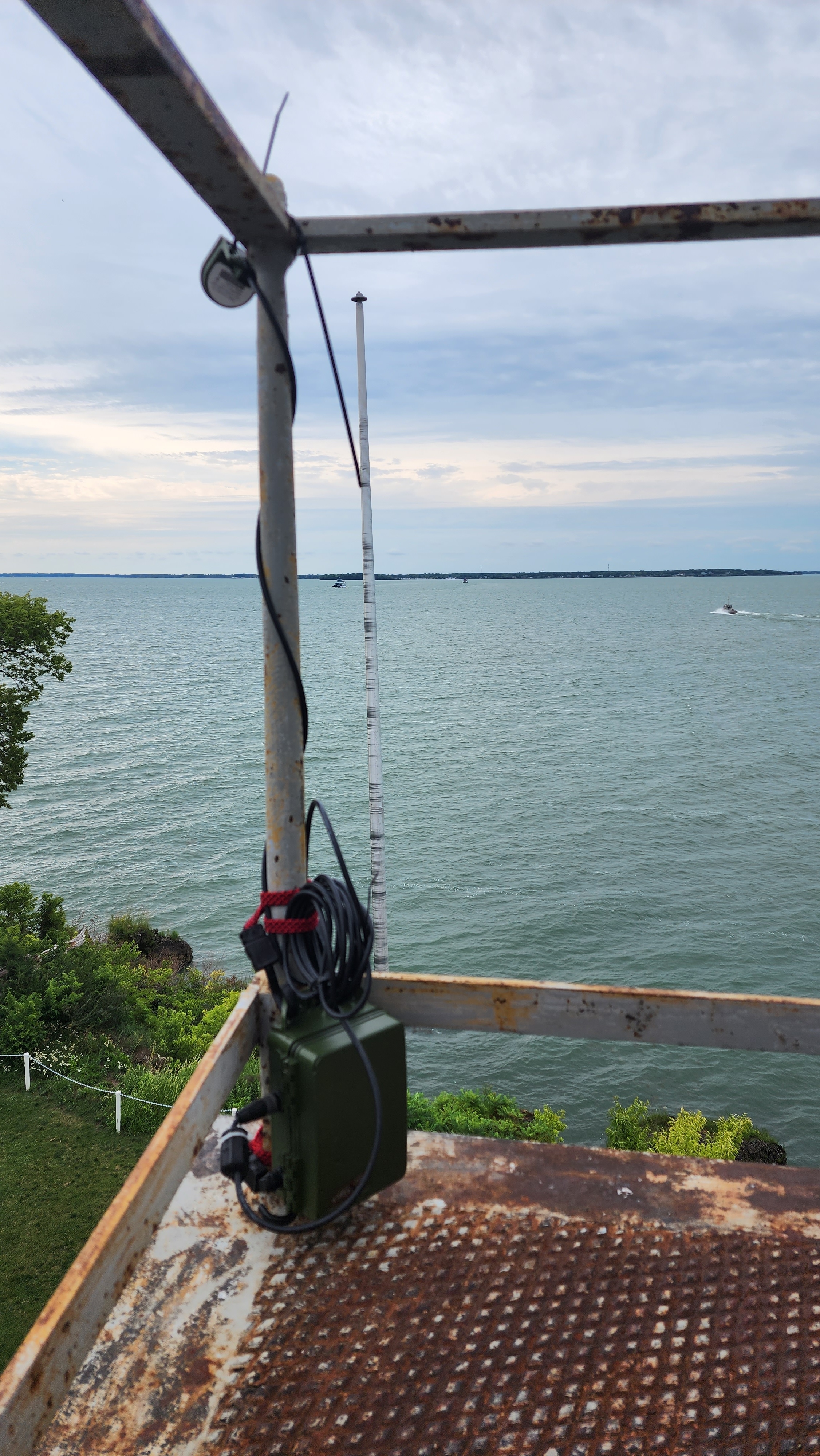 Lake Erie Islands Nature and Wildlife Center research coordinator Dr. Amy Alford places a bat audio detection device on the light tower of the South Bas Island lighthouse. The lighthouse is owned and operated by Ohio Sea Grant's Stone Laboratory.